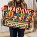 Person holding a colorful hippie doormat featuring peace signs, flowers, and vibrant tie-dye artwork
