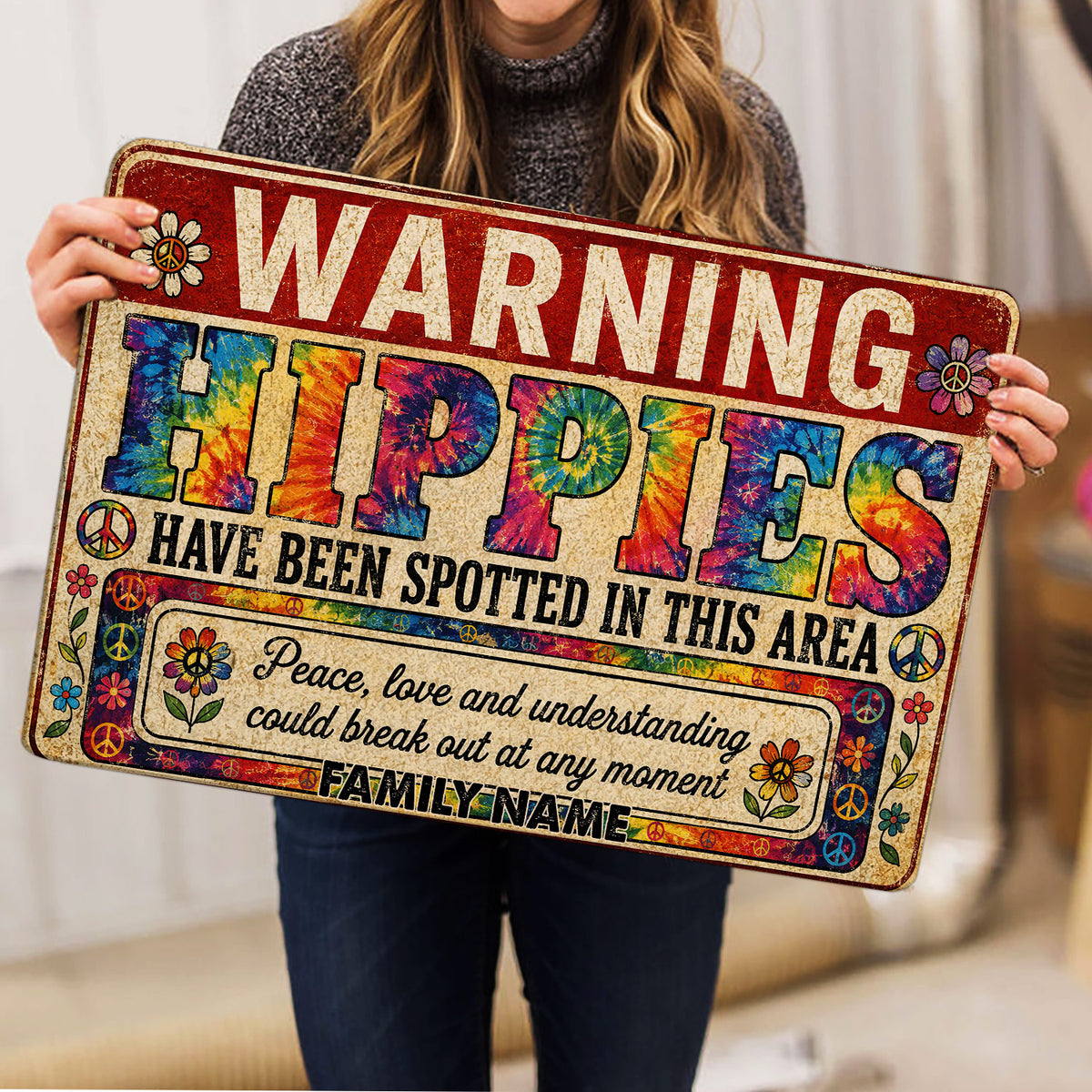 Person holding a colorful hippie doormat featuring peace signs, flowers, and vibrant tie-dye artwork