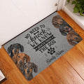 Dachshund entryway rug displayed by a door on hardwood flooring with playful dog portraits