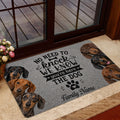 Dachshund doormat shown in a home entrance with a welcoming message and several dog portraits