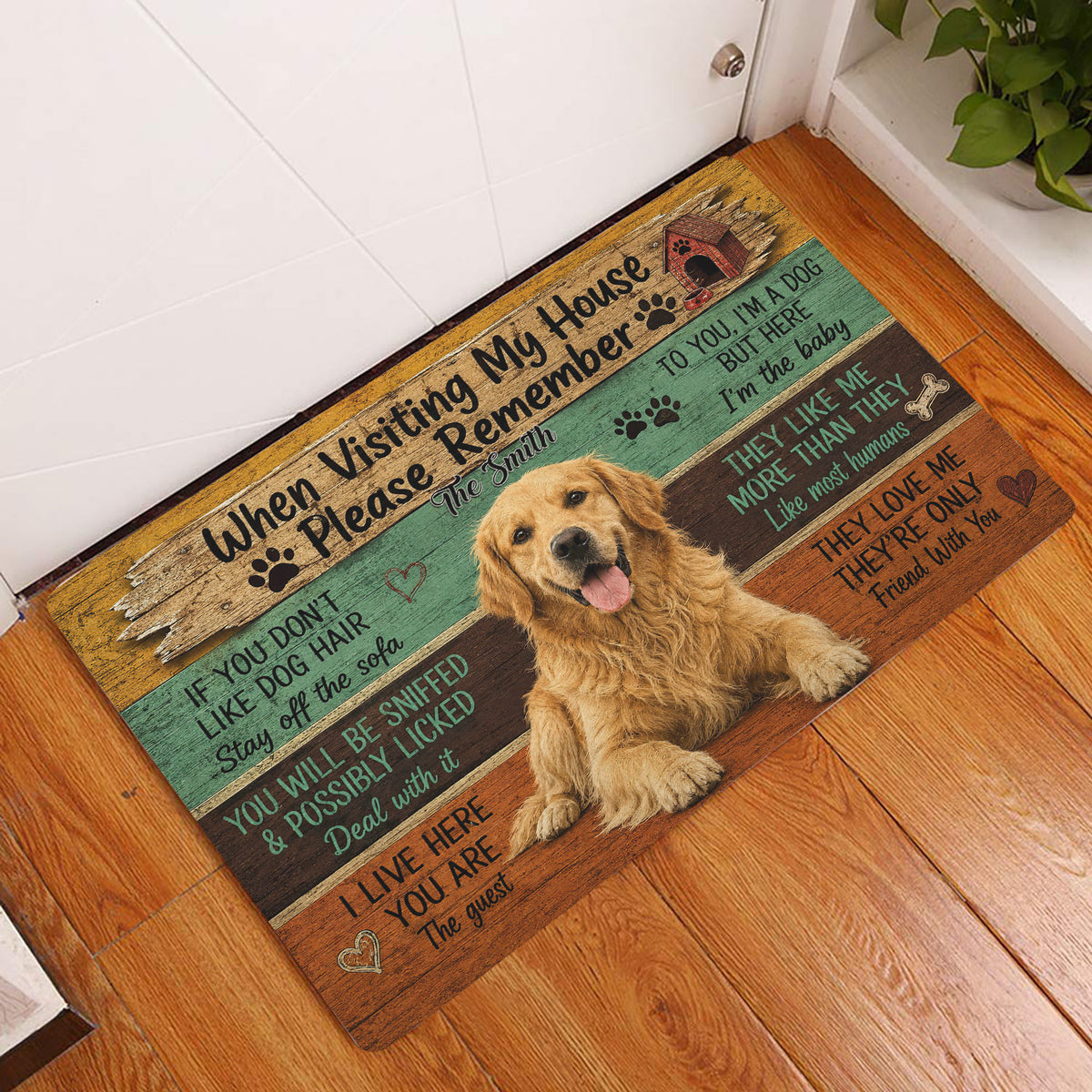 Golden Retriever entryway rug displayed by a white door on hardwood flooring with rustic colorful artwork