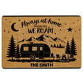 Camping doormat featuring a travel trailer, mountain landscape, pine trees, stars, moon and campfire artwork