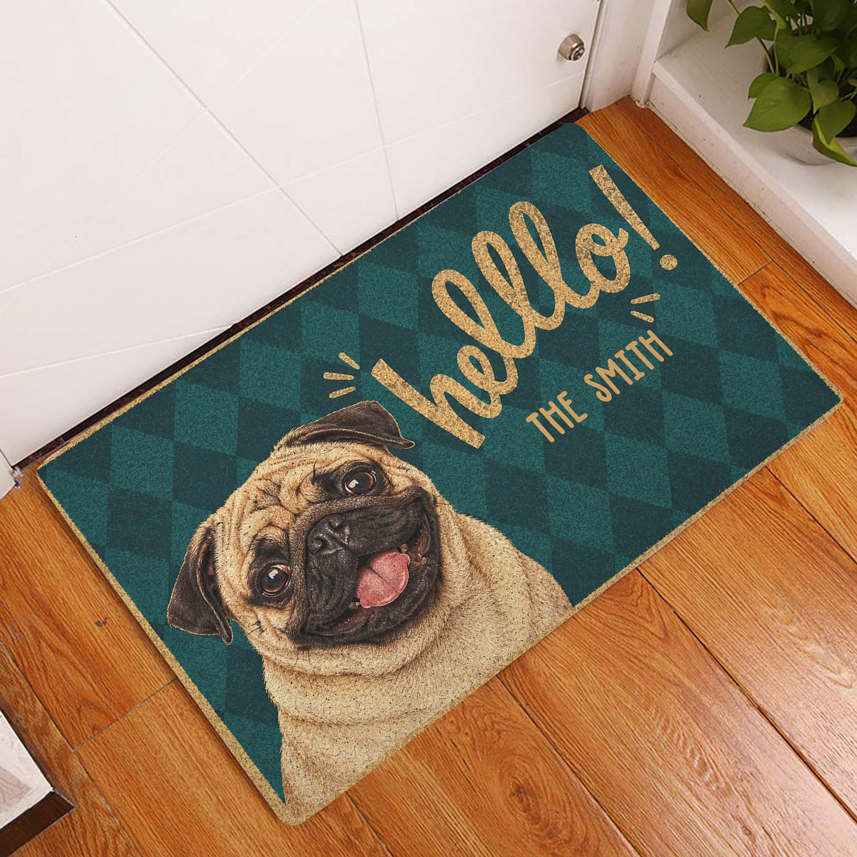 Pug welcome doormat displayed at an indoor entryway on a warm wood floor