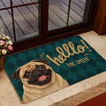 Pug door mat styled inside a glass doorway with dark teal and gold artwork