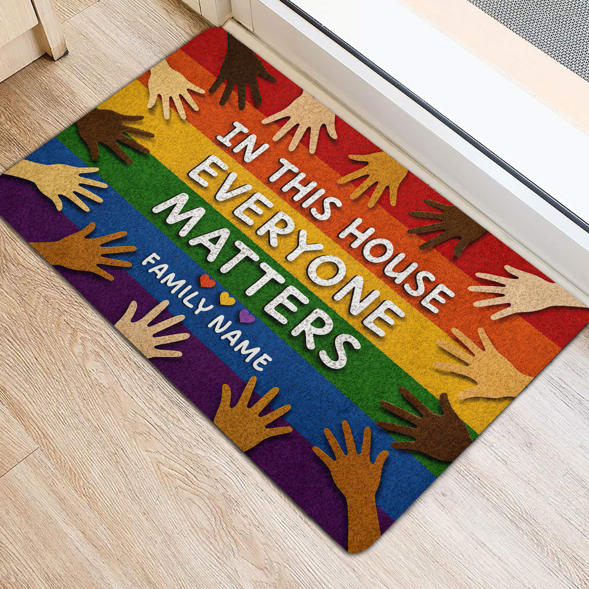 Colorful LGBT entryway rug with rainbow stripes and diverse hand artwork beside a doorway