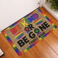 LGBT rainbow Be Kind doormat displayed inside a home entryway on a wood floor