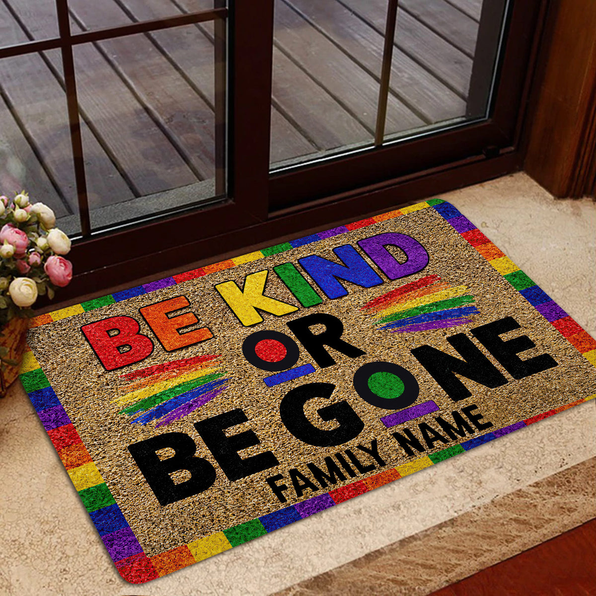Rainbow LGBT Be Kind doormat styled at a home entrance with warm interior decor