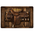 Western cowboy saddle, rope, and Southwestern textile artwork on a rustic wood-plank doormat