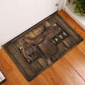 Cowboy saddle doormat styled at an indoor entryway beside a white door and wood floor