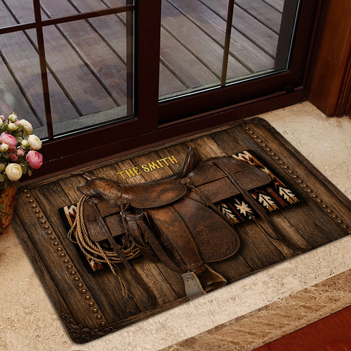 Cowboy saddle entryway doormat displayed beside a glass door in a warm home setting