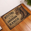 Cowboy boots and ranch welcome doormat styled in a wood entryway beside a white door