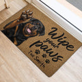 Rottweiler door mat placed near an entrance with a raised paw portrait and welcoming script