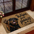 Rottweiler entryway mat styled beside a glass door in a warm home entrance