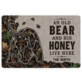 Bear doormat featuring a woodland illustration, honey jar, bees, autumn leaves, and rustic entryway lettering