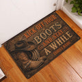 Cowboy-themed doormat displayed at an indoor entryway beside a white door and wood floor