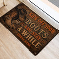 Western cowboy boot and hat doormat styled near an indoor doorway on light flooring