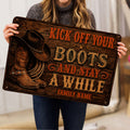Cowboy-themed doormat held indoors, featuring Western boots, hat, rope, and vintage lettering