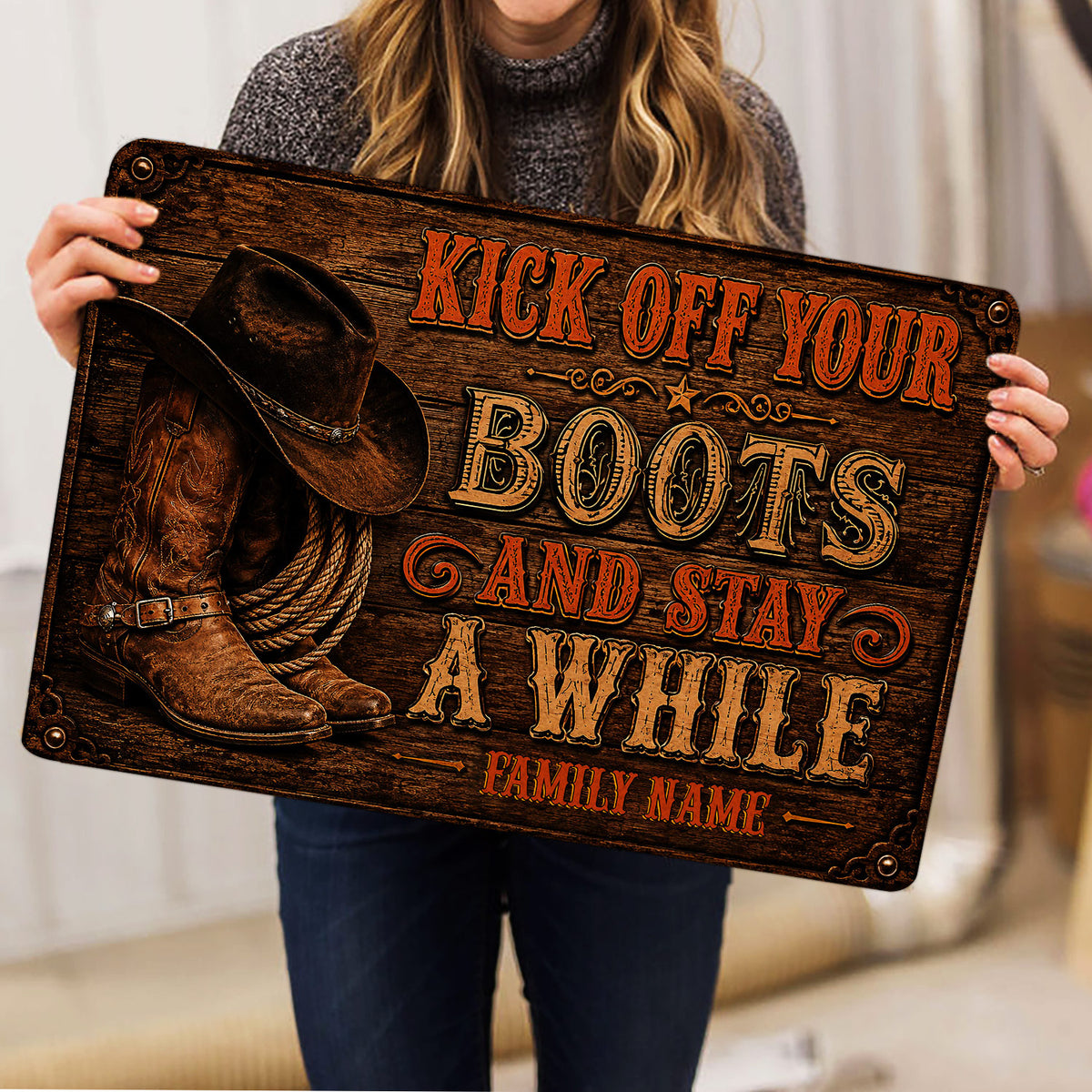 Cowboy-themed doormat held indoors, featuring Western boots, hat, rope, and vintage lettering