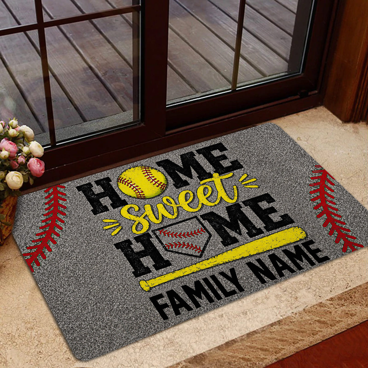 Softball family-themed doormat styled inside a glass doorway with a yellow bat and softball artwork