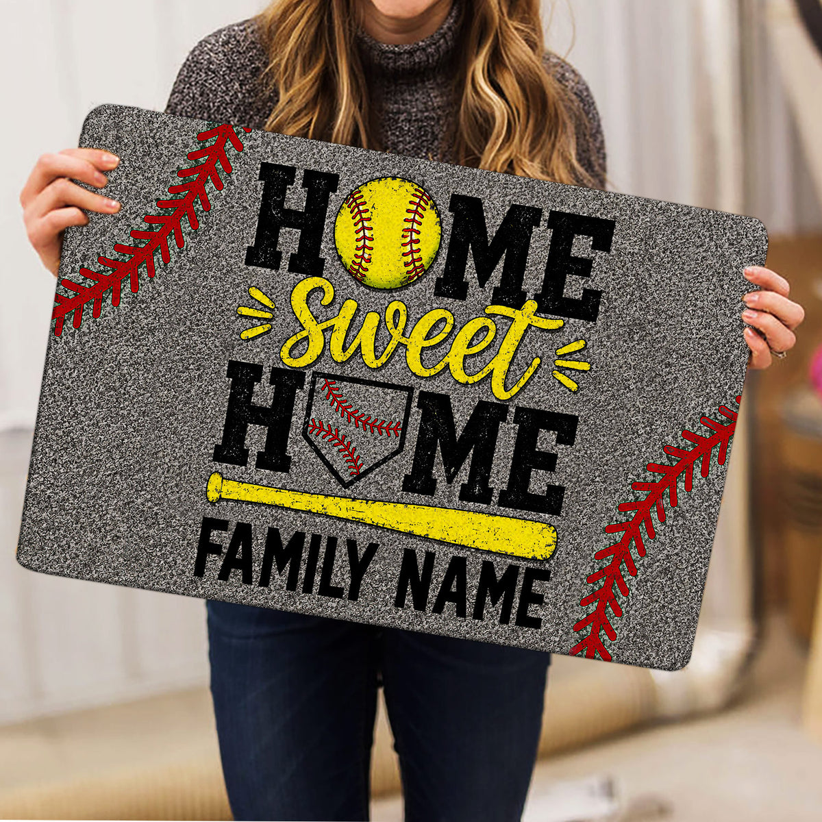 Softball doormat held indoors showing home-themed artwork with a softball, bat, glove, and red stitching