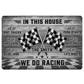 Racing doormat with crossed checkered flags, weathered wood design, bold lettering, and a black and gray finish