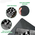 Racing doormat detail showing checkered flag artwork, felt-like printed surface, and black rubber backing