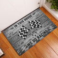 Checkered flag racing doormat displayed at a home entrance on a warm wood floor
