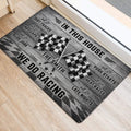 Racing entryway mat positioned beside a doorway with crossed flags and bold black and gray artwork