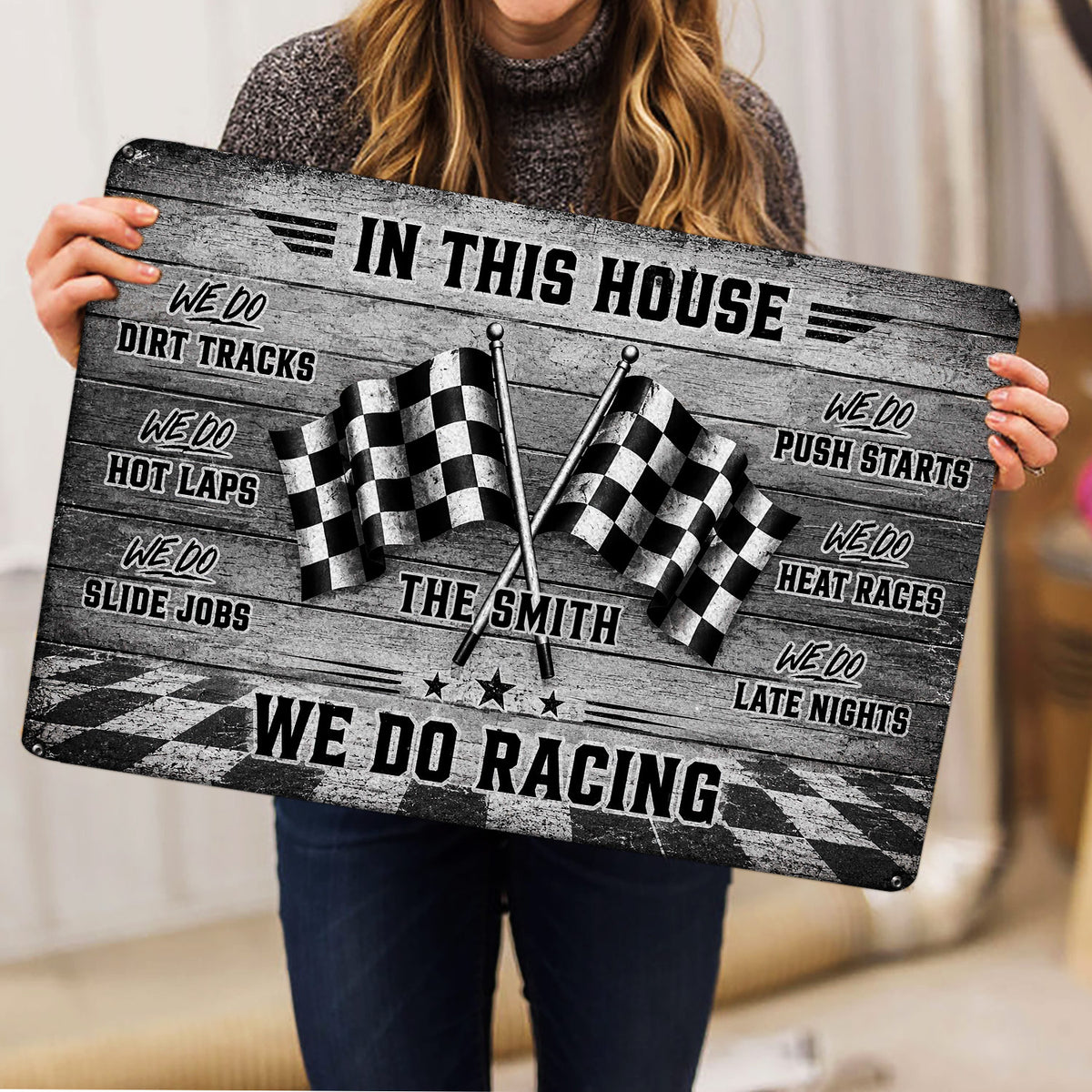 Racing doormat held indoors, showing crossed checkered flags, bold typography, and a black and gray design