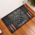 Fishing hook and rugged star-and-stripe doormat displayed in an indoor entryway on a wood floor