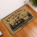 Camping entryway doormat displayed by a front door on hardwood flooring with an RV and mountain scene