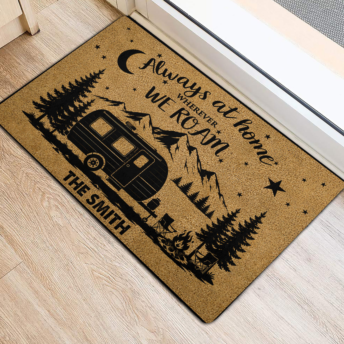 Scenic camping door mat beside a doorway featuring an RV, mountains, pine trees, moon, and campfire