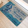Mermaid door mat styled at an entrance with ocean waves, sailboat, and starfish artwork