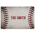 Baseball doormat with realistic red stitching along both sides and centered block lettering