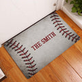 Baseball-themed doormat displayed in an indoor entryway on warm wood flooring
