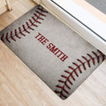 Baseball stitching design on a doormat positioned beside an interior doorway