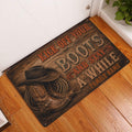 Cowboy-themed doormat displayed at an indoor entryway with boots, hat and rope artwork