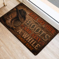 Western cowboy door mat placed near an entrance, featuring rustic wood styling and boot artwork