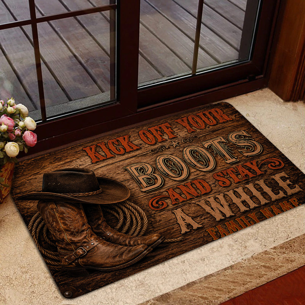Cowboy entryway mat shown by a glass door with western boots, hat and rope design