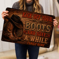Cowboy doormat held indoors, showing rustic western artwork with boots, hat and rope