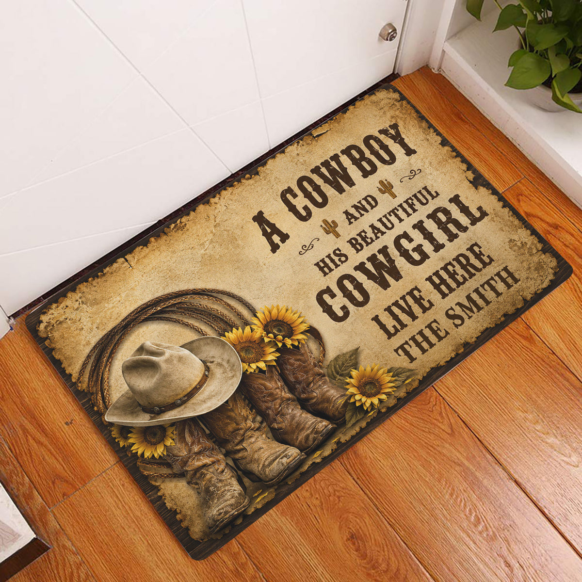 Cowboy and cowgirl western doormat displayed at an indoor entryway beside a white door and wood floor
