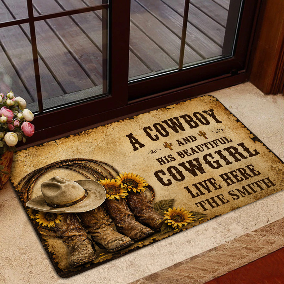 Cowboy-themed entryway mat styled beside a glass door with a hat, boots, rope, and sunflower artwork