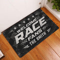 Racing-themed entryway rug displayed on a wood floor with bold white lettering and dark tire-track artwork