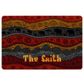 African-inspired doormat with elephant silhouettes, geometric patterns, and red, gold, and charcoal bands