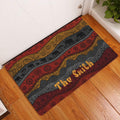 African elephant entryway rug displayed by a white door on a wood floor with bold patterned bands