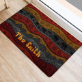 African-inspired elephant door mat positioned at an entryway with red, gold, and charcoal artwork