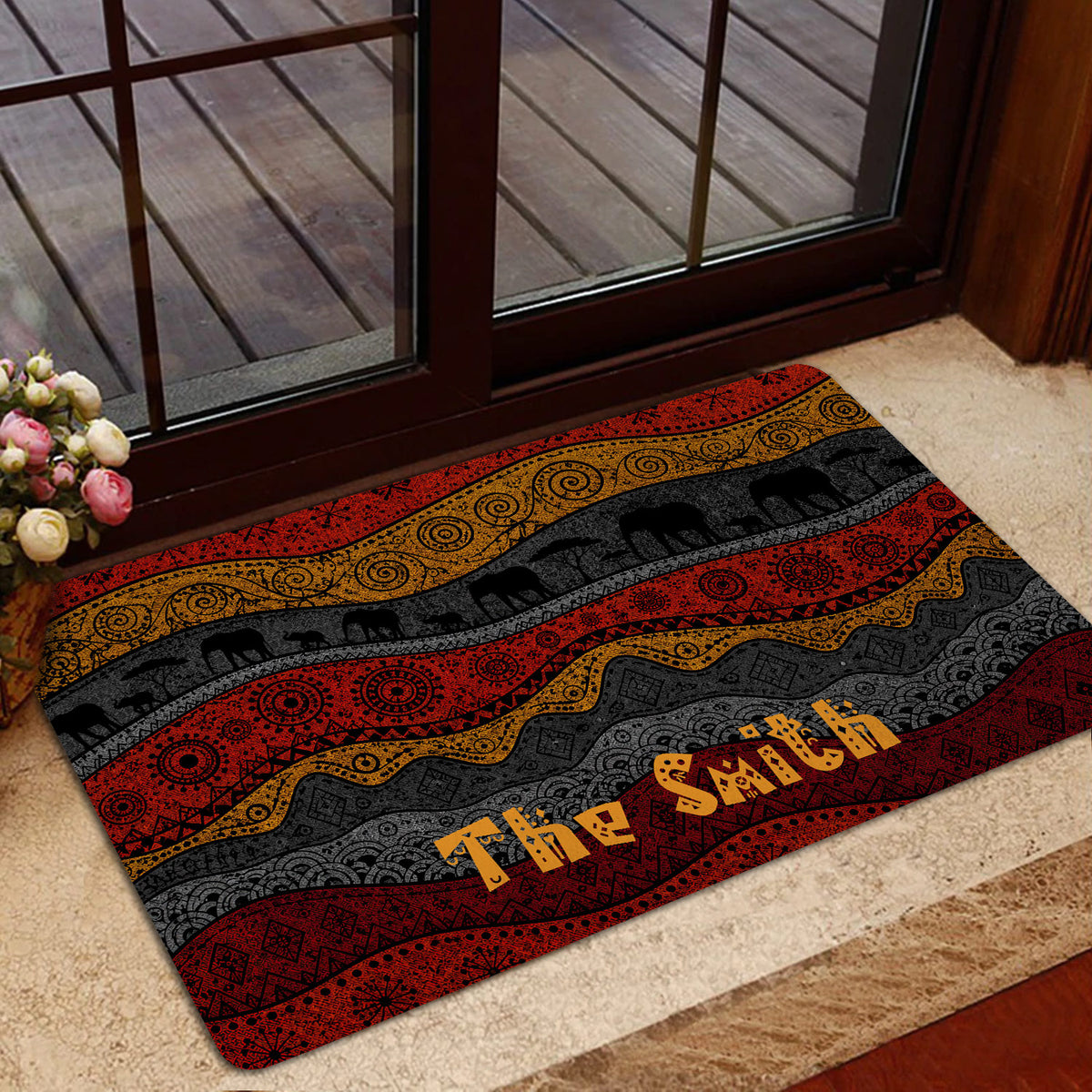 African elephant doormat styled near a glass door with colorful geometric patterns and warm earth tones