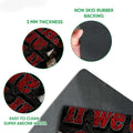 Feature detail view of a racing doormat showing the printed surface, rubber backing and low-profile edge