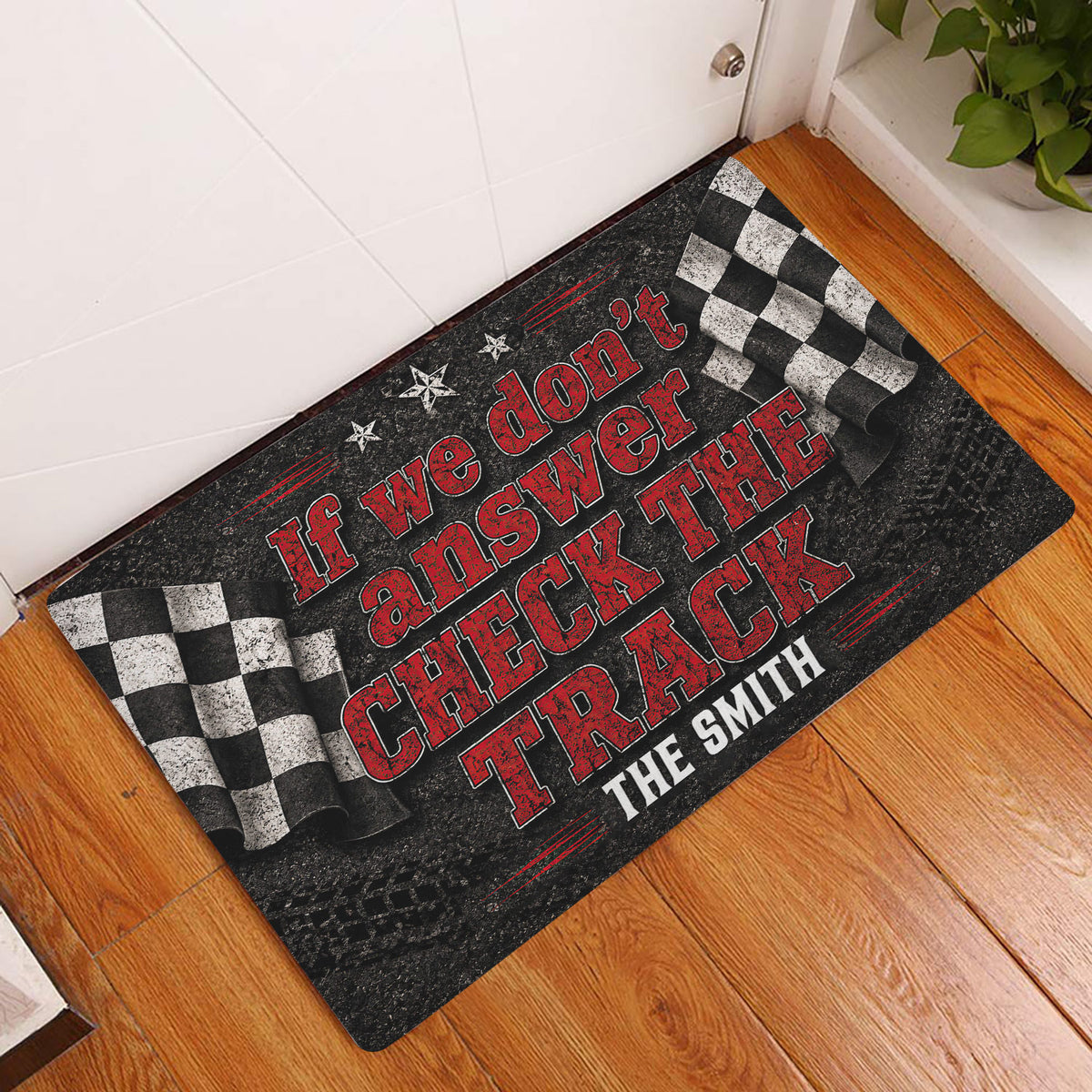 Racing-themed doormat displayed in a home entryway on a warm wood floor beside a door