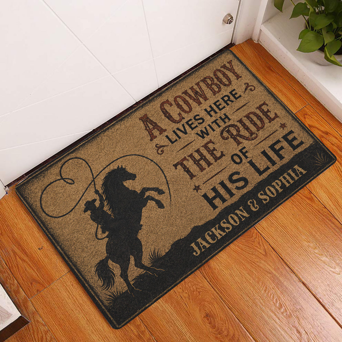 Cowboy entryway rug displayed beside a white door on a warm wood floor with rustic Western artwork